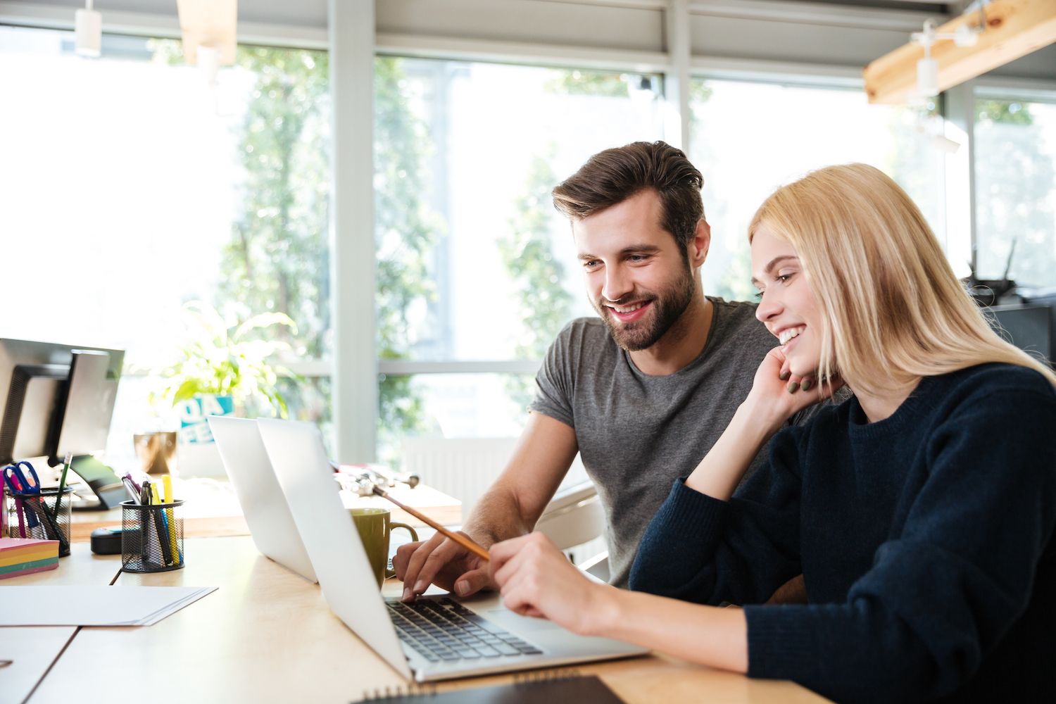 Man and woman looking over a laptop